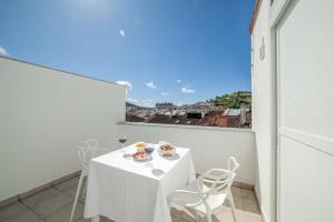 a white table and chairs on a balcony with a view at Principado de Aracena I in Aracena +29 photos