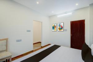 a bedroom with a bed and a red door at Hotel O Dream Vegas in Hyderabad