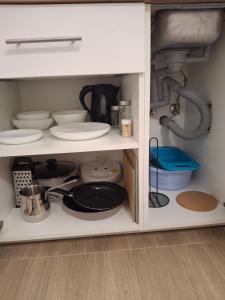 a kitchen cabinet filled with dishes and utensils at Villa Ivana in Koper +2 photos