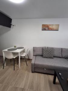 a living room with a couch and a table at Villa Ivana in Koper