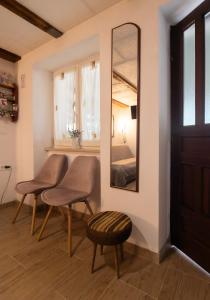 a room with two chairs and a mirror at APARTMA BrdonKA in Dobrovo