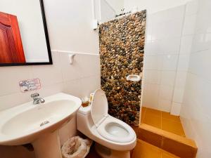 a bathroom with a sink and a toilet and a shower at Hosteria Chuquitos - Chalupas in Tena +41 photos