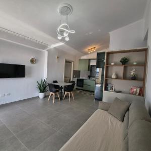 a living room with a couch and a table at Kypsel Apartment in Durrës