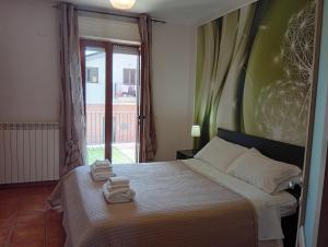 a bedroom with a bed with towels on it at Mimì Home in Isernia