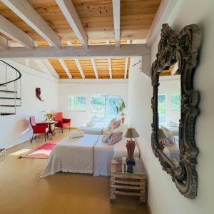 a bedroom with a bed and a mirror at Goodmuda in Grândola