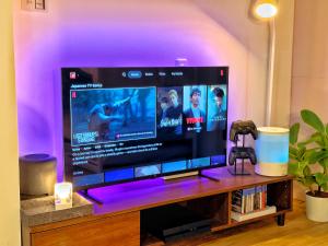 a large flat screen tv sitting on a entertainment center at Maison Stay Kobe in Kobe
