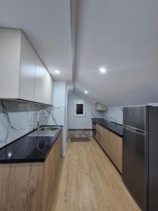 a large kitchen with wooden counters and stainless steel appliances at FloVa Apartment in Valjiosi