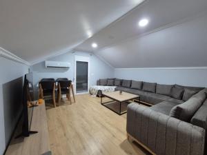 a living room with a couch and a table at FloVa Apartment in Valjiosi