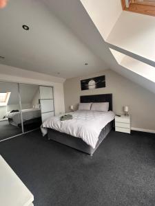 a bedroom with a large white bed in a attic at 6 Pegasus Place in Lerwick