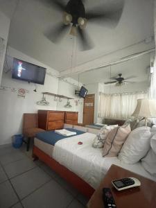 a bedroom with a bed and a ceiling fan at Posada Casa Adriana in Puerto Vallarta