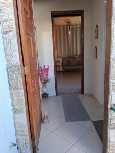 a door leading to a room with a couch at LOFT da Serra Imperial in Petrópolis