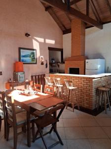 a dining room with a table and chairs and a fireplace at LOFT da Serra Imperial in Petrópolis
