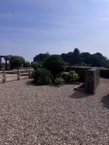 a park with a wooden fence and a bench at The Barn With A View in Portskewett