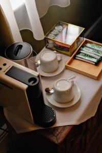 a table with a tea set on top of it at 41 Whitfield Street Hotel in London