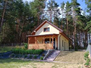 a small house in the middle of a yard at Jagódka Roztocze in Ulów +9 photos