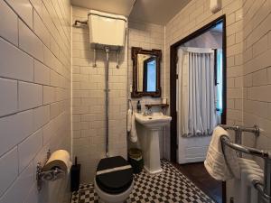 a bathroom with a toilet and a sink at 41 Whitfield Street Hotel in London +13 photos