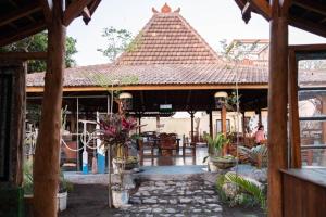 an outside view of a restaurant with a roof at Sunrise Lodge and Lounge Hotel in Panji