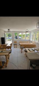 a large room with wooden benches and windows at Jezerina in Šavnik