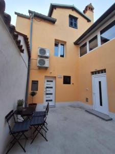a patio with a table and chairs in front of a house at Villa Ivana in Koper