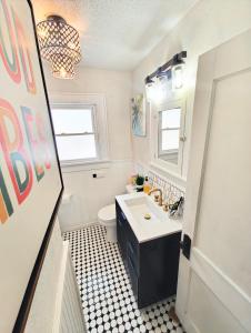 a bathroom with a white sink and a toilet at World Solo Travel's Welcomed At St Pete Home in St. Petersburg +36 photos