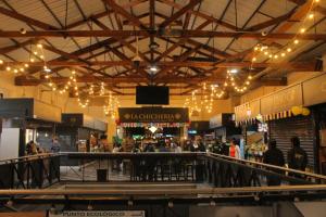 a shopping mall with people walking around and lights at Iwana stay in Bogotá