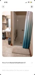 ein Badezimmer mit Dusche und blauem Duschvorhang in der Unterkunft Healing Properties in Sioux Falls + 17 Fotos