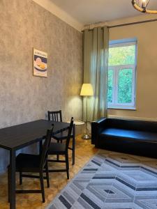 a living room with a table and a couch at Cent Hostel - Lublin Centrum in Lublin +108 photos