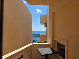 a room with a window with a view of the ocean at Triton Sea View Studios in Tsoutsouros