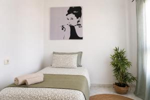 a bedroom with a bed and a painting on the wall at Bright House, Pool & Workspace near Medano Beach in El Médano +51 photos