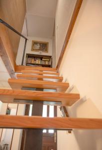 a staircase in a house with wooden treads at APARTMA BrdonKA in Dobrovo