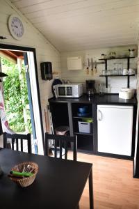 a kitchen with a black counter top and a table at B&B Olsegården in Tvååker