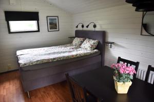 a small bedroom with a bed and a table at B&B Olsegården in Tvååker
