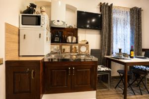 a kitchen with a sink and a refrigerator at History Apartments Cetății in Sibiu