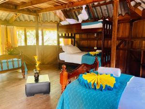 a bedroom with two bunk beds in a room at Hosteria Chuquitos - Chalupas in Tena