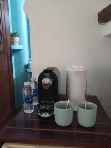 a counter with two bowls and a coffee maker on it at Casa Bellavista Chaouen in Chefchaouen