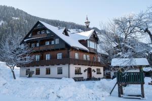a large house with snow on the roof at Weitgasserhof in Schladming
