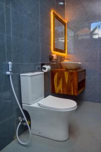a bathroom with a white toilet and a sink at N-line Residency Hotel in Arusha