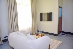 a living room with a white chair and a table at N-line Residency Hotel in Arusha