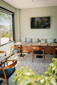 a living room with a couch and chairs at WG Hotel Lake View in Ksamil