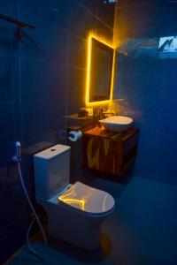 a bathroom with a white toilet and a sink at N-line Residency Hotel in Arusha +1 photo
