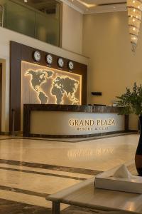 a sign for the grand plaza resort and club in a lobby at Grand Plaza Hotel New Giza in Kafr Abū ʼumaydah +40 photos