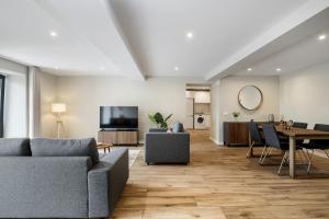 a living room with a couch and a table at Oceanea Apartment by Homie in Santa Cruz