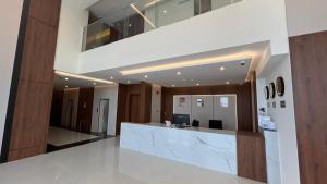 an office lobby with a reception desk and a staircase at Eioraa Hotel فندق إيوراء in Khamis Mushayt