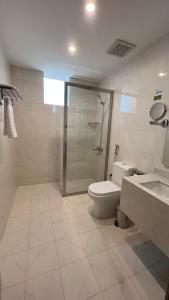 a bathroom with a shower and a toilet and a sink at Eioraa Hotel فندق إيوراء in Khamis Mushayt +24 photos