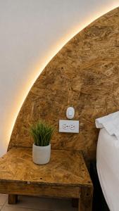 a bedroom with a table with a plant on it at Casa Wilson in Cartagena de Indias