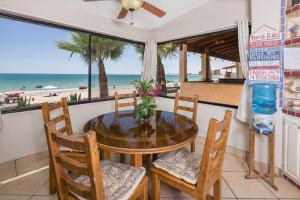 a dining room with a table and chairs and the beach at Super Beachfront Condo Ground Level on Sandy Beach in Puerto Peñasco