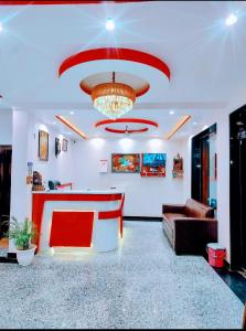 a living room with a couch and a chandelier at Hotel sphatic in Chitrakoot