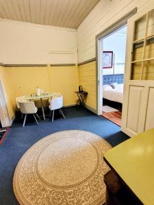 a room with a table and chairs and a bed at Her Home in Purranque