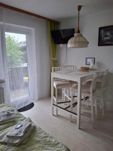 a white table and chairs in a room with a window at Ferienwohnung 6 Bergblick in Sankt Gilgen