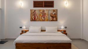 a bedroom with a large bed with two lamps at Ceylon tea resort Ella in Ella